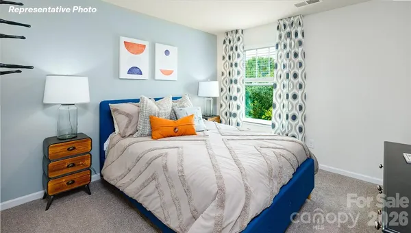 a bedroom with a bed and a dresser in it