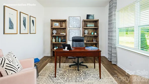 a view of a workspace with furniture and a potted plant