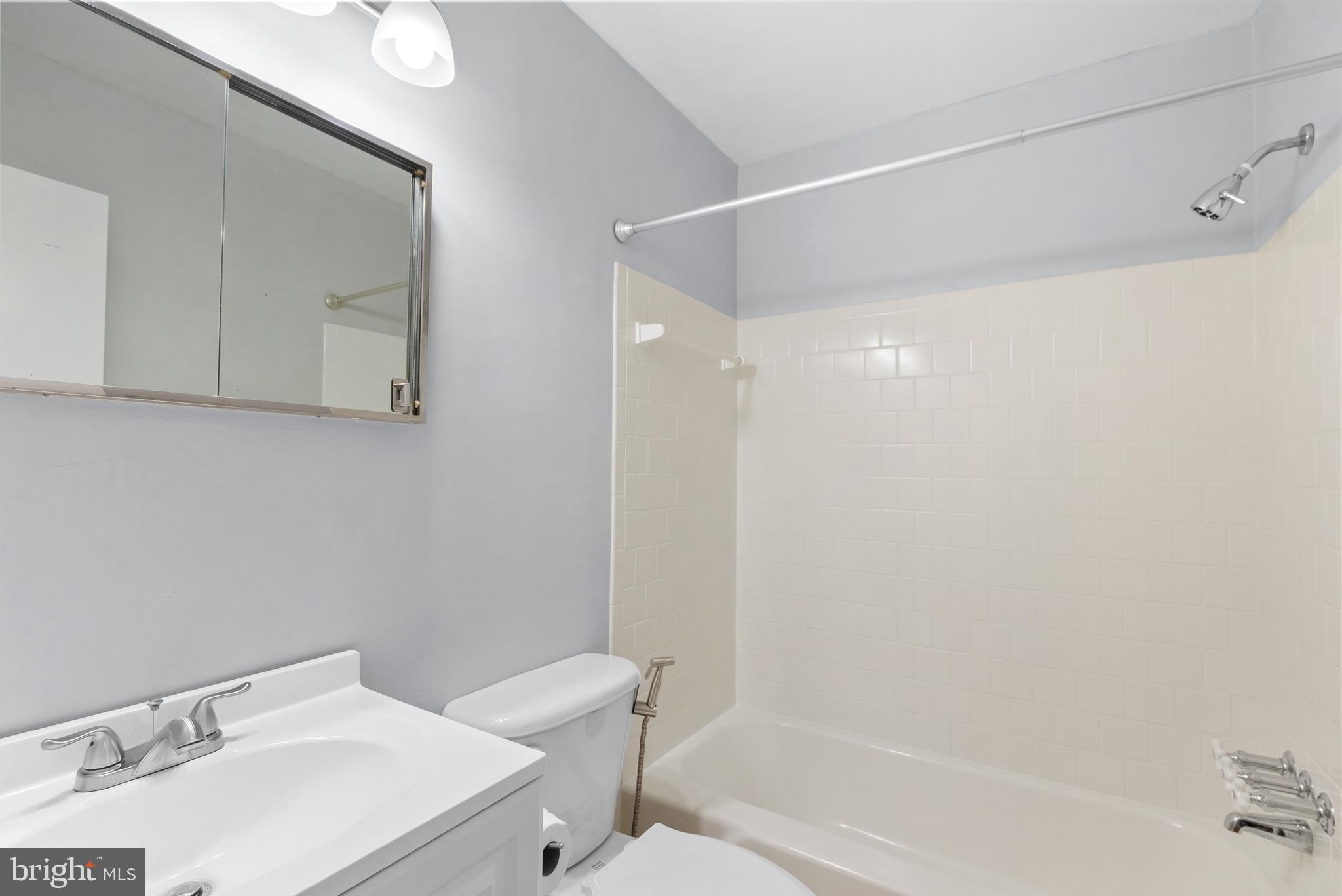 1201 Chillum Manor Road Hyattsville, MD 20783 - Photo 22 of 49 a bathroom with a sink a toilet and shower