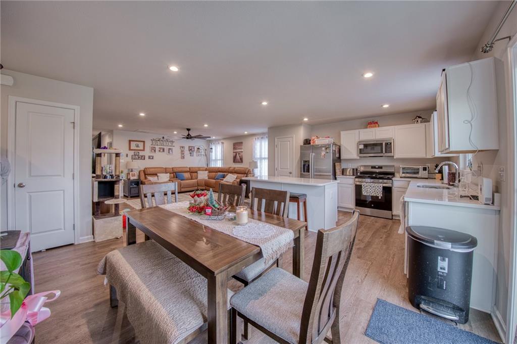 113 Dominic Drive Butler, PA 16001 - Photo 13 of 45 a kitchen with stainless steel appliances granite countertop a dining table chairs stove refrigerator and cabinets