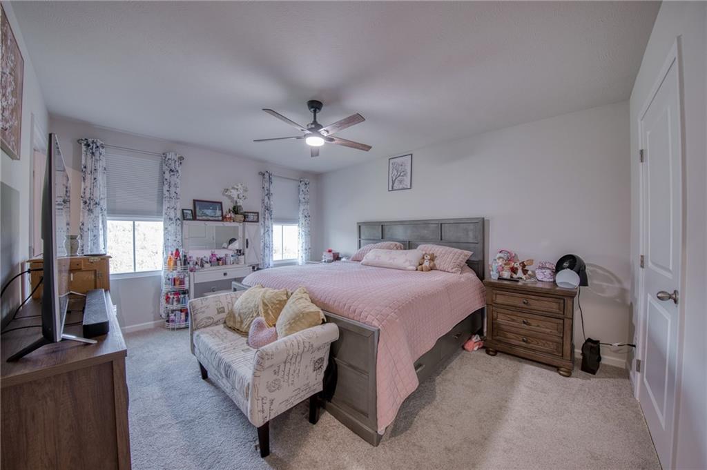 113 Dominic Drive Butler, PA 16001 - Photo 22 of 45 a spacious bedroom with a bed a couch and dresser