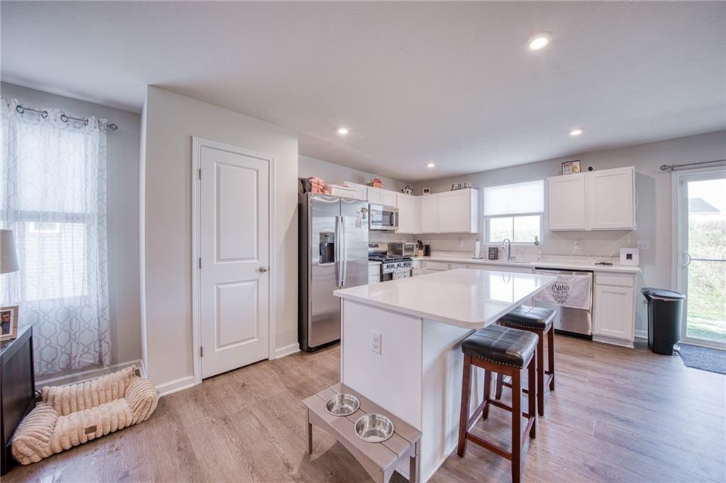 113 Dominic Drive Butler, PA 16001 - Photo 10 of 45 a open kitchen with white cabinets and stainless steel appliances