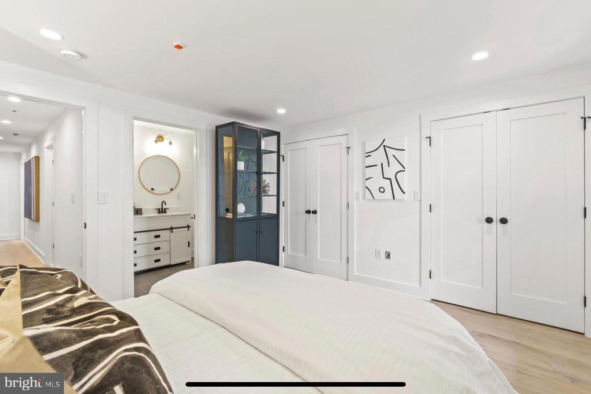 625 Quebec Place Northwest, Unit 1 Washington, DC 20010 - Photo 12 of 20 a bedroom with a bed and a chandelier