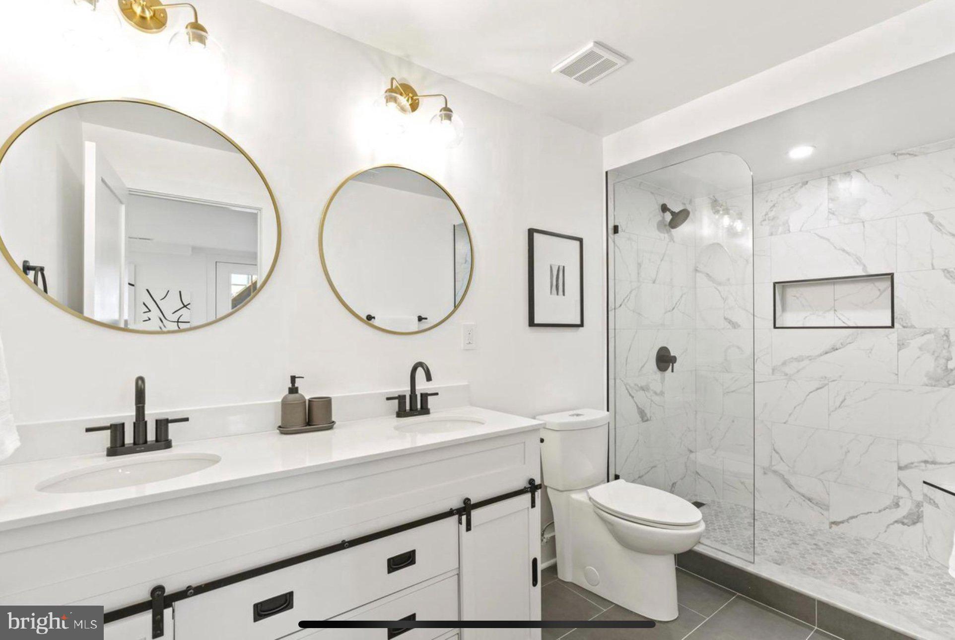 625 Quebec Place Northwest, Unit 1 Washington, DC 20010 - Photo 13 of 20 a bathroom with a toilet a sink and a mirror