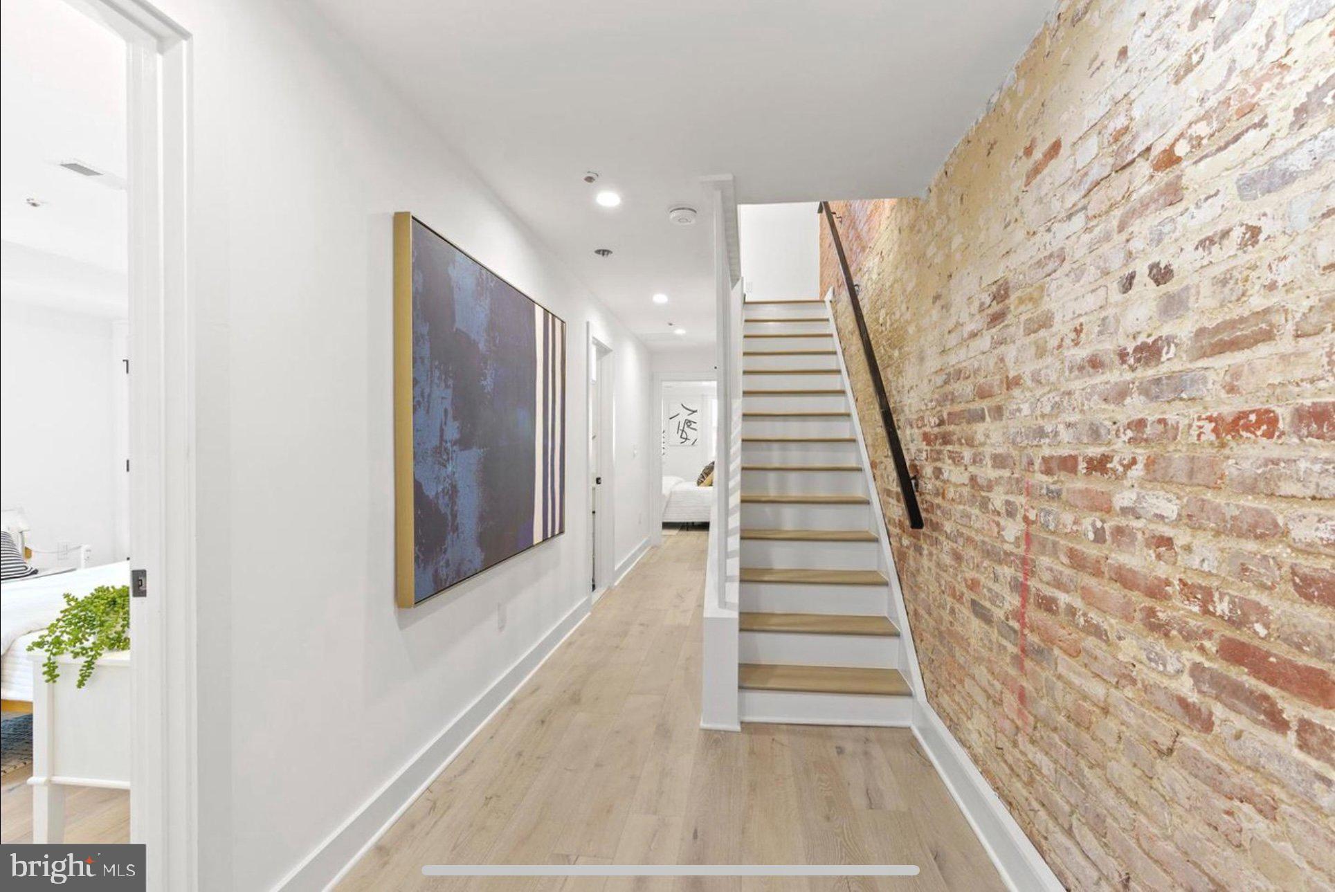625 Quebec Place Northwest, Unit 1 Washington, DC 20010 - Photo 8 of 20 a view of a hallway with wooden floor and stairs