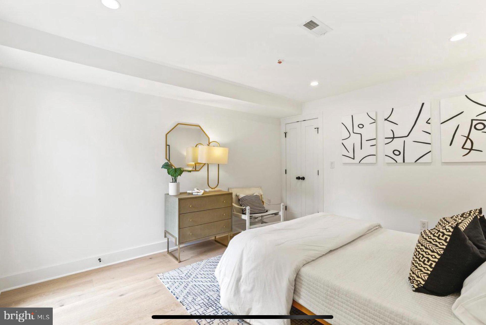 625 Quebec Place Northwest, Unit 1 Washington, DC 20010 - Photo 10 of 20 a bedroom with a bed and a chandelier
