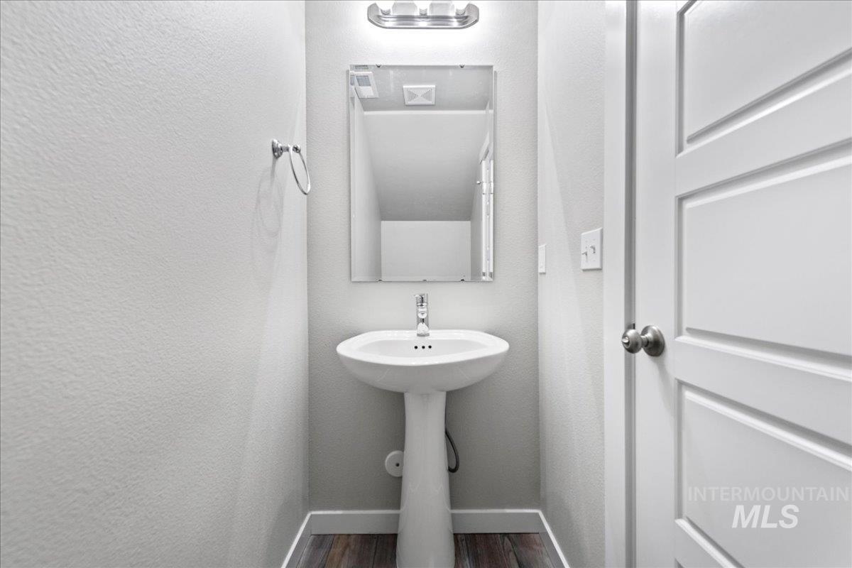 2471 East Goldstone Street Meridian, ID 83642 - Photo 14 of 27 Half bath with a textured wall and dark wood-style flooring