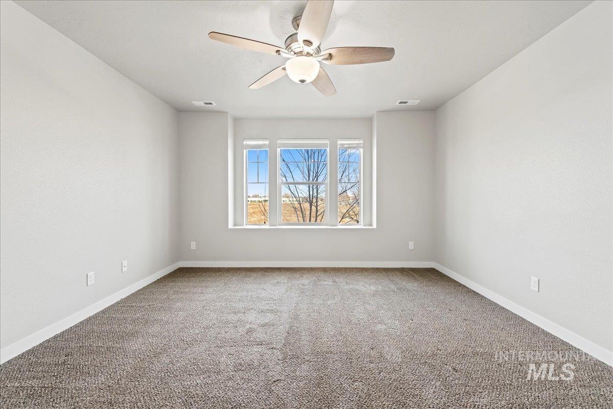 2471 East Goldstone Street Meridian, ID 83642 - Photo 21 of 27 Unfurnished room with light carpet and a ceiling fan