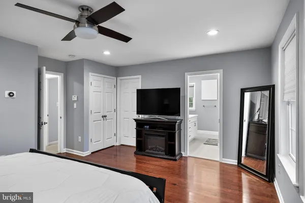 a bedroom with furniture and a flat screen tv