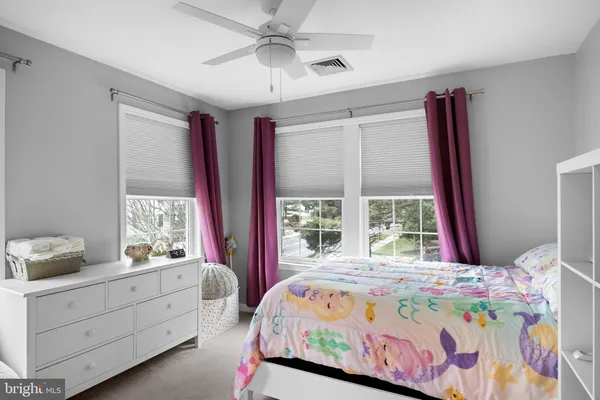 a bedroom with a bed dresser and a window