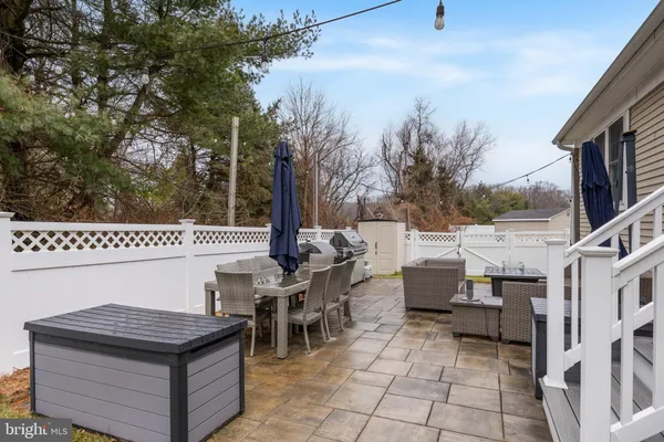 a view of a patio with table and chairs and couches