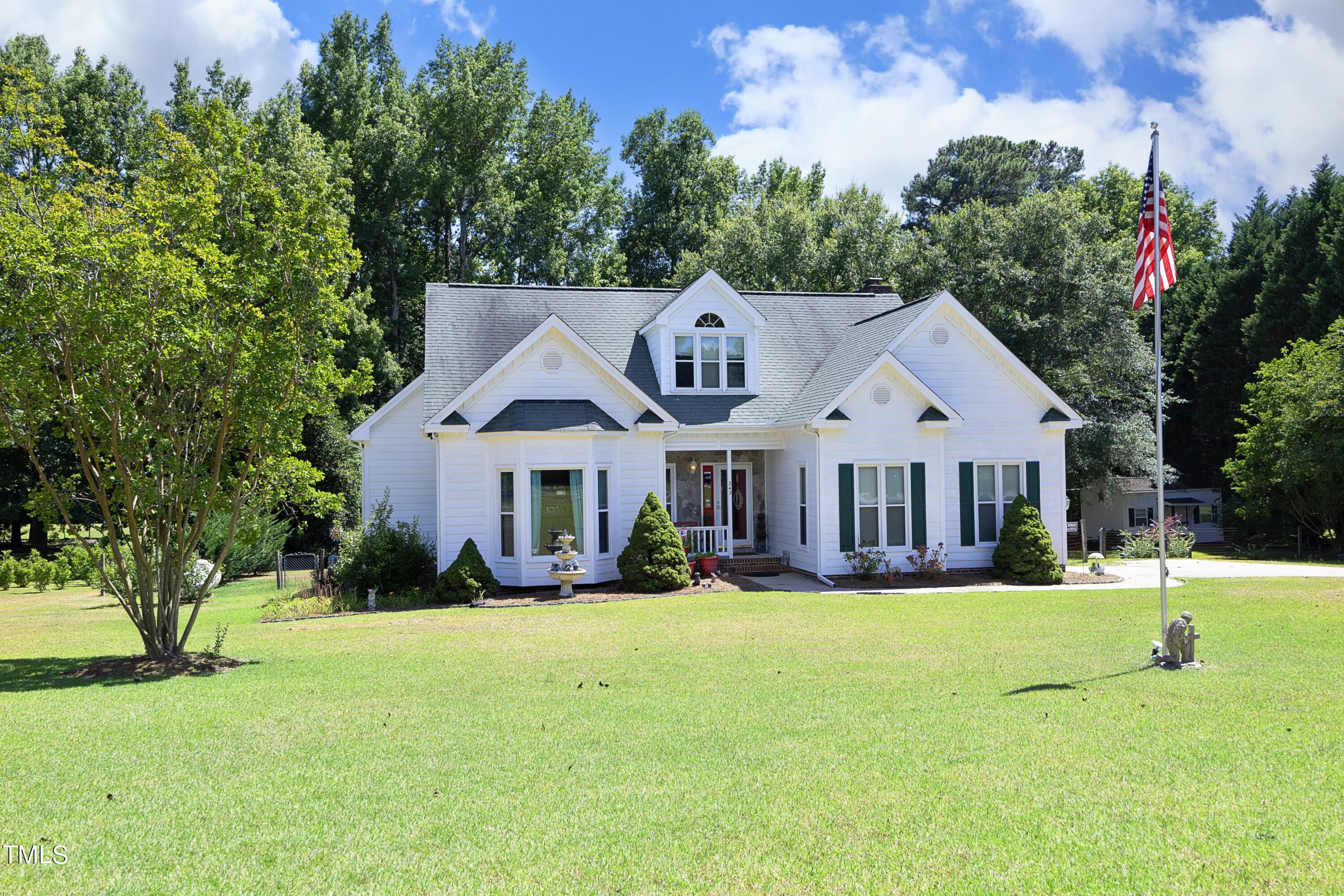 243 Bradley Drive Benson, NC 27504 - Photo 1 of 43 a front view of a house with a yard and trees