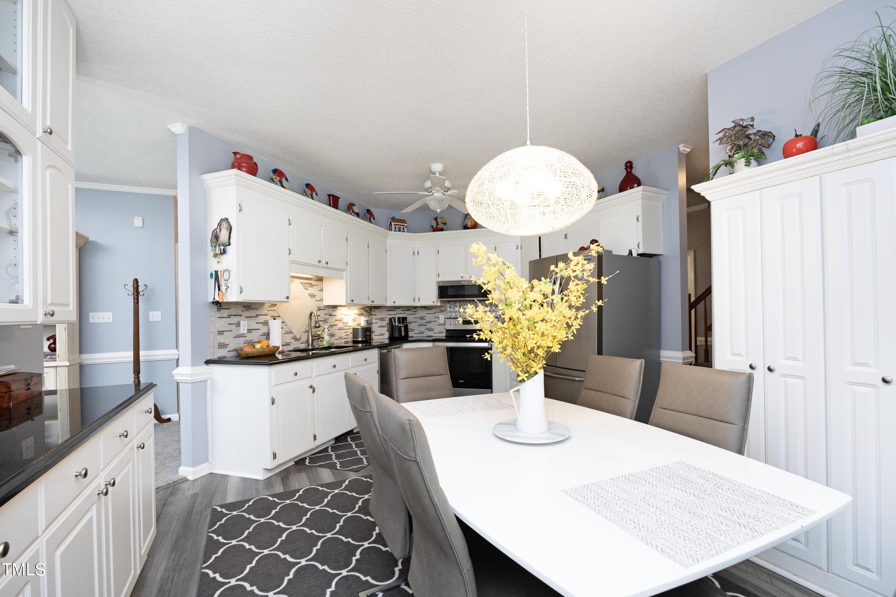 243 Bradley Drive Benson, NC 27504 - Photo 14 of 43 a kitchen with a table and chairs in it