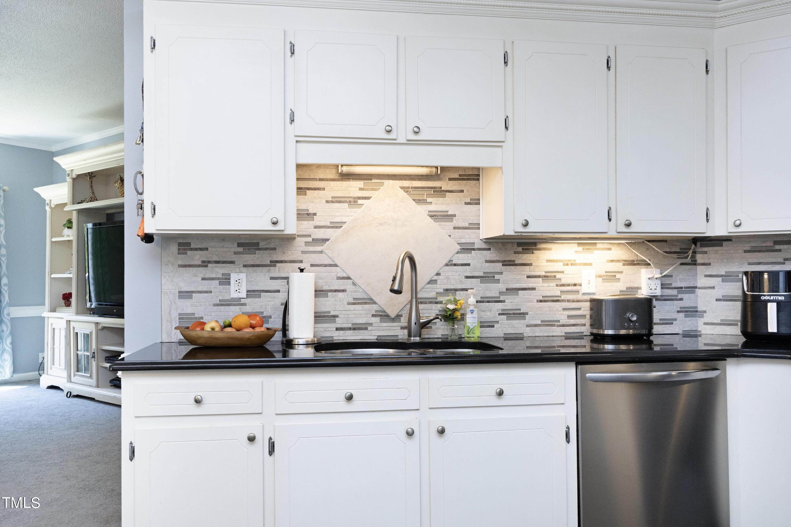 243 Bradley Drive Benson, NC 27504 - Photo 15 of 43 a kitchen with stainless steel appliances granite countertop a sink a stove and white cabinets