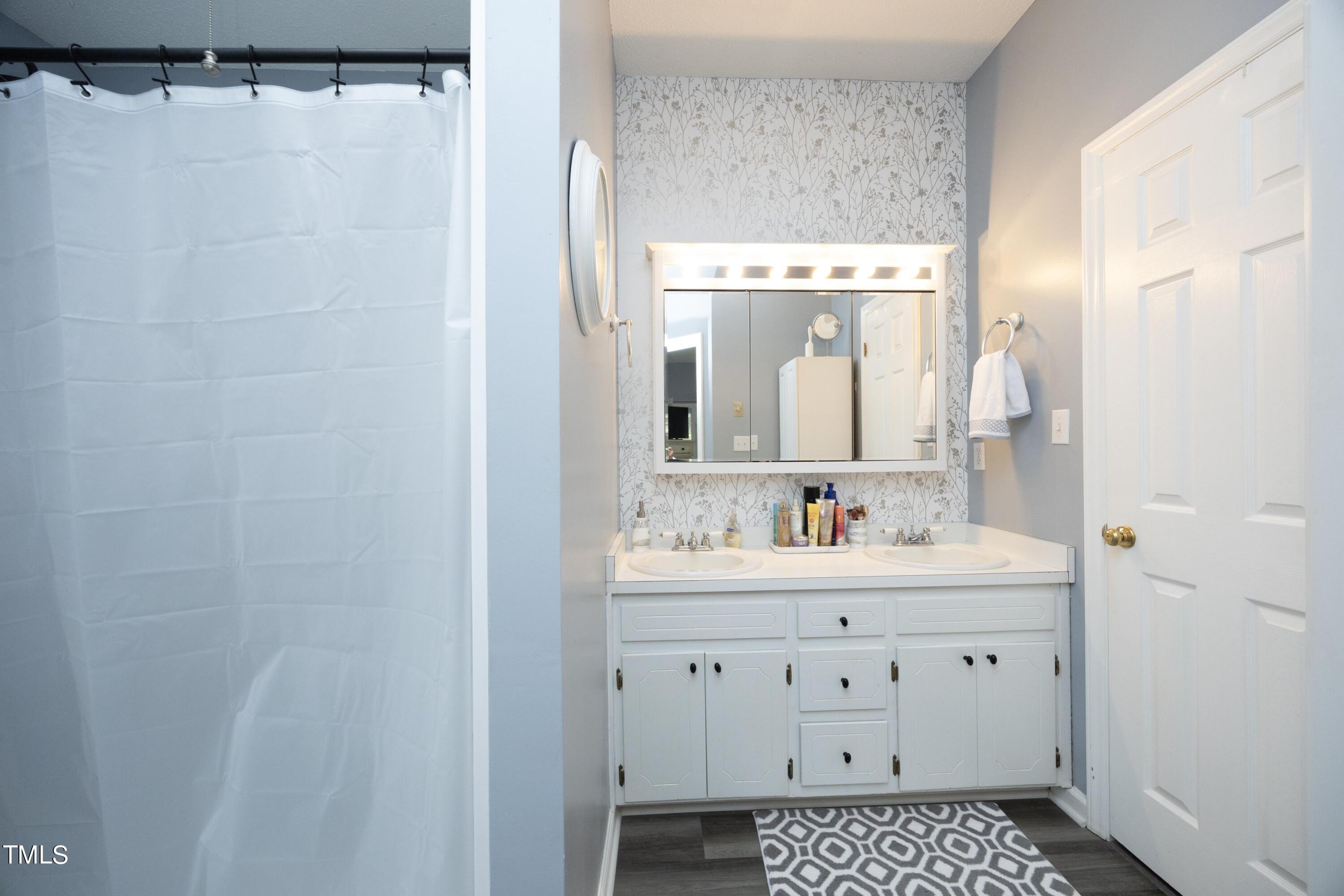 243 Bradley Drive Benson, NC 27504 - Photo 18 of 43 a bathroom with a bathtub a sink and a mirror