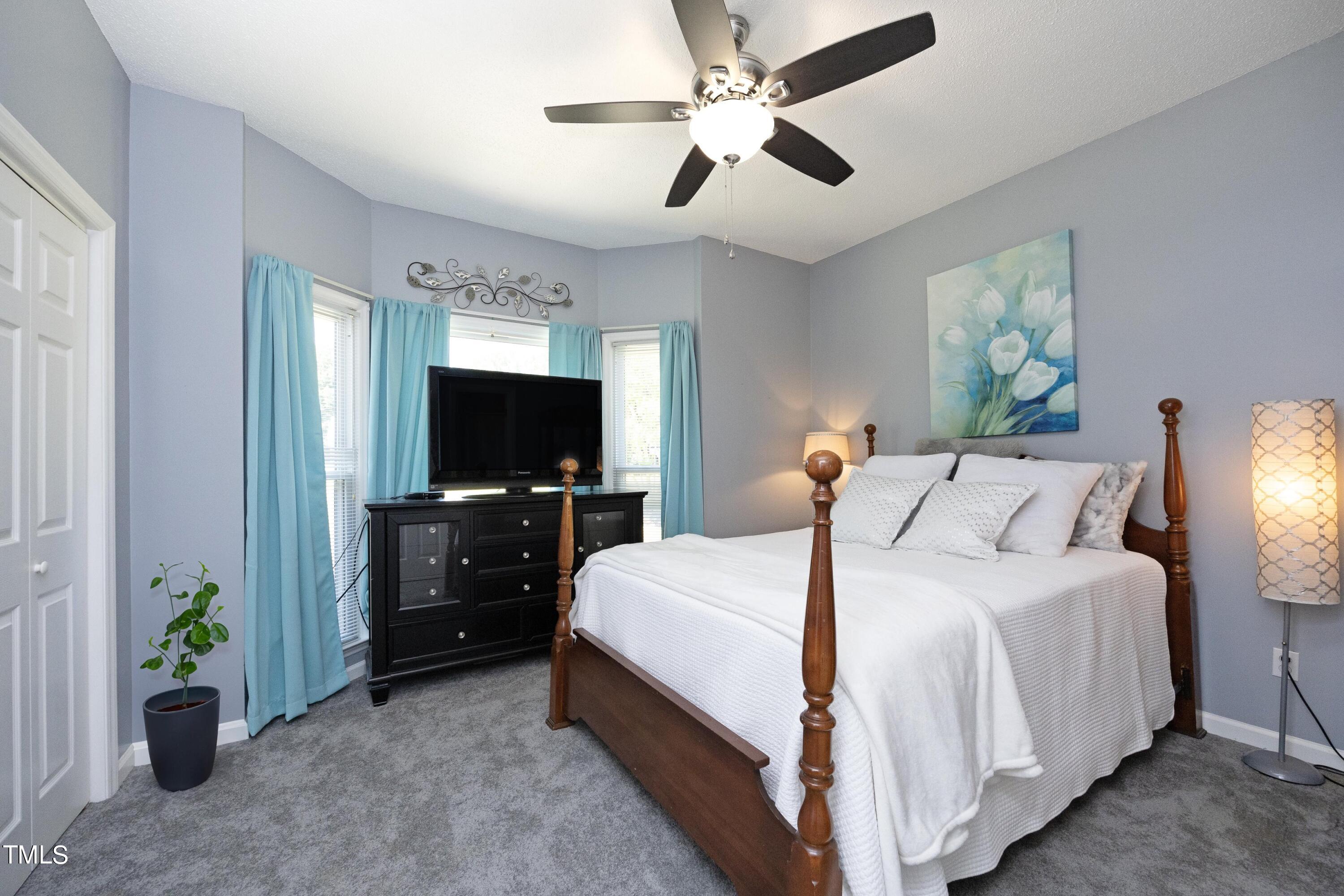 243 Bradley Drive Benson, NC 27504 - Photo 20 of 43 a bedroom with a bed and a flat tv screen on dresser