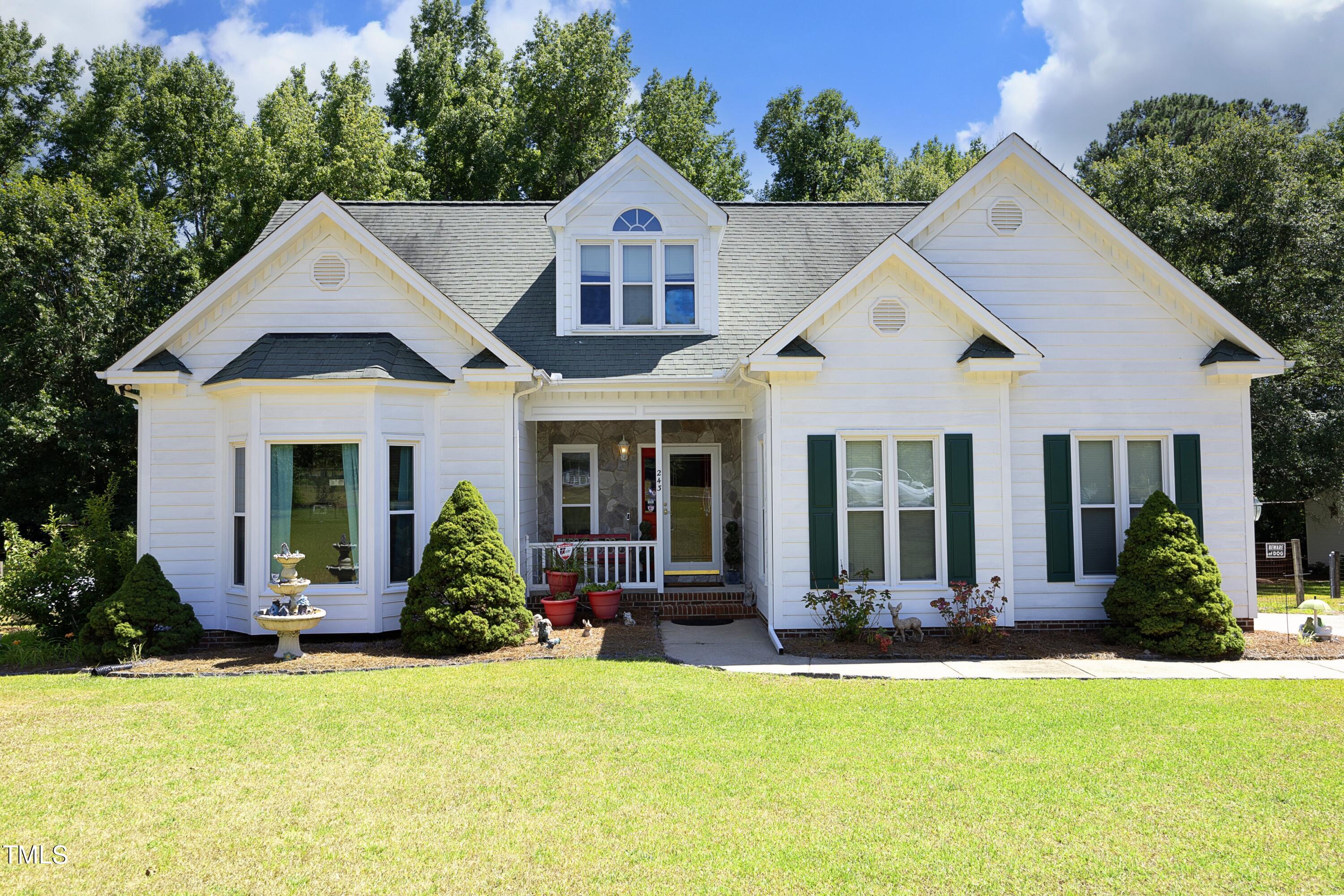 243 Bradley Drive Benson, NC 27504 - Photo 2 of 43 a front view of a house with trees in the background
