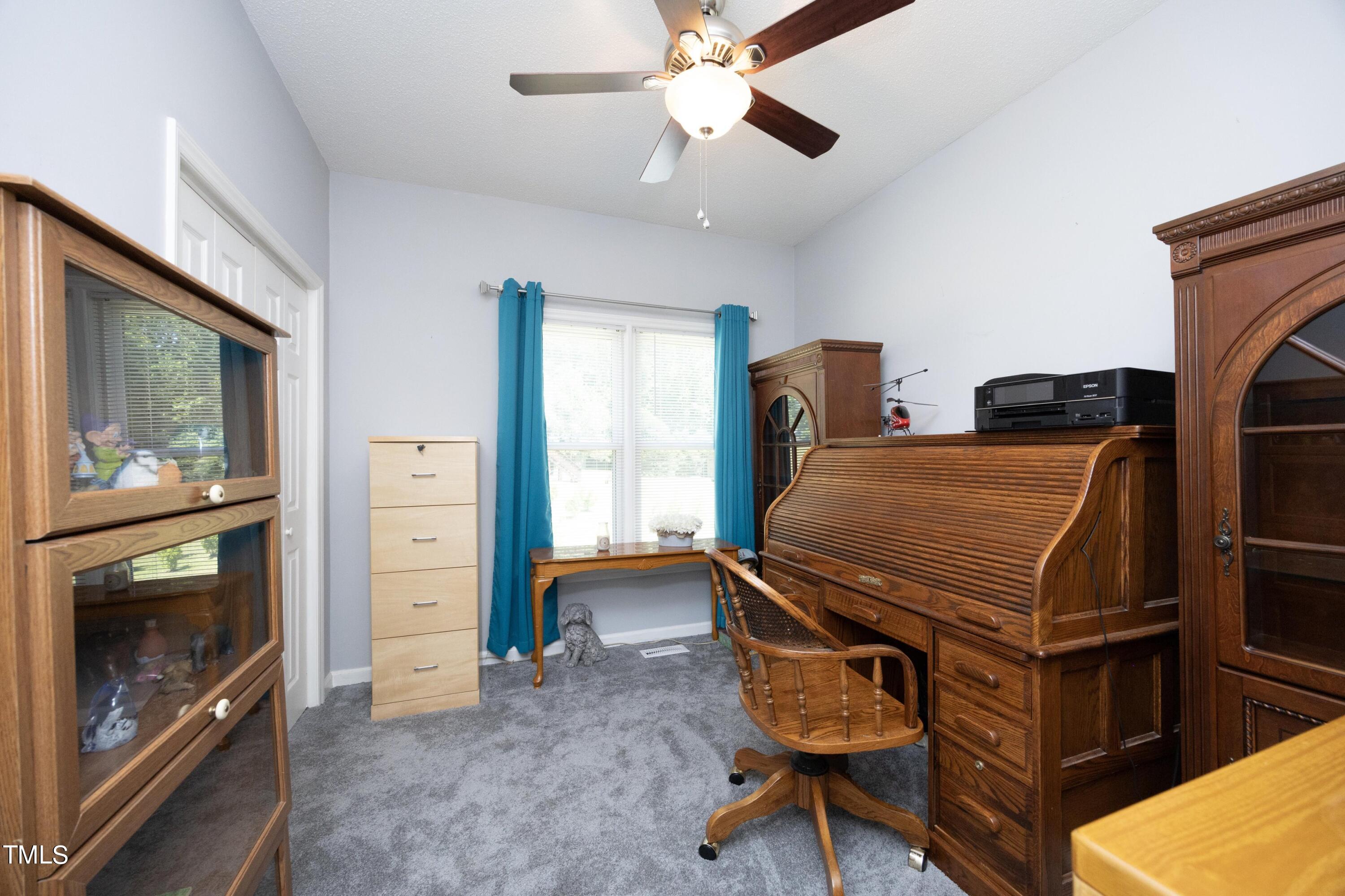 243 Bradley Drive Benson, NC 27504 - Photo 23 of 43 a bedroom with furniture and a fireplace