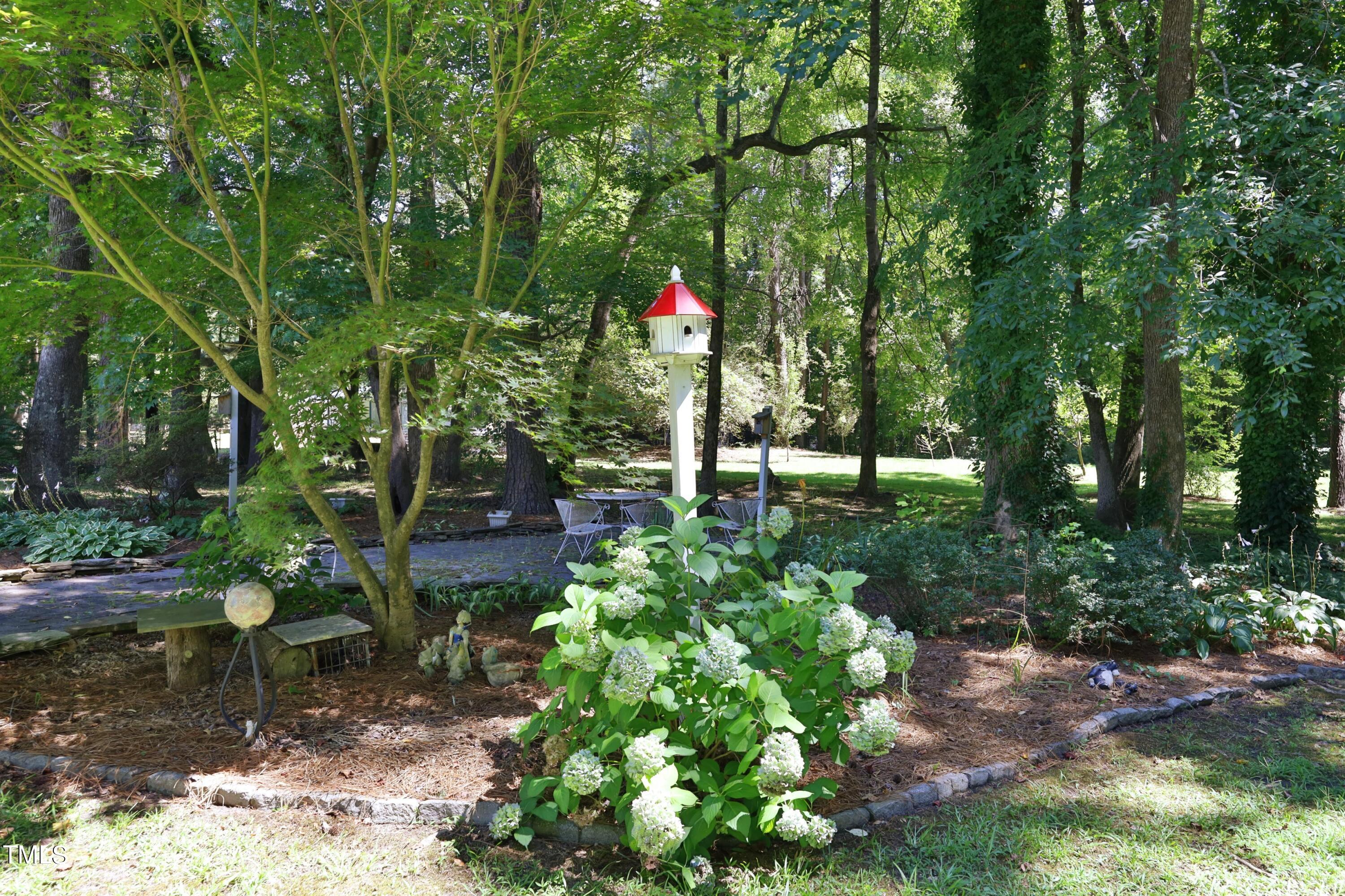 243 Bradley Drive Benson, NC 27504 - Photo 33 of 43 a backyard of a house with lots of green space and outdoor seating