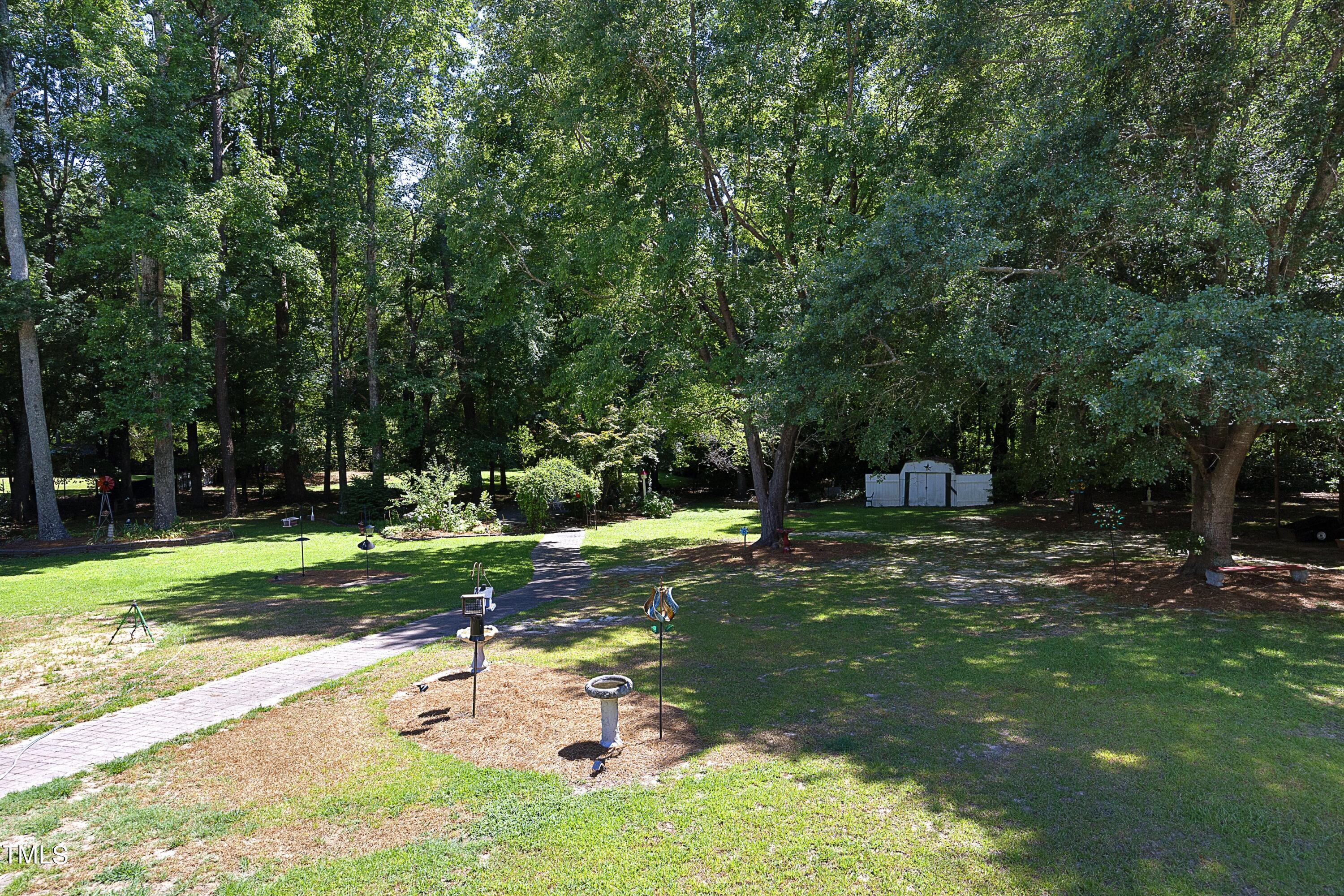 243 Bradley Drive Benson, NC 27504 - Photo 40 of 43 a view of a backyard with large trees