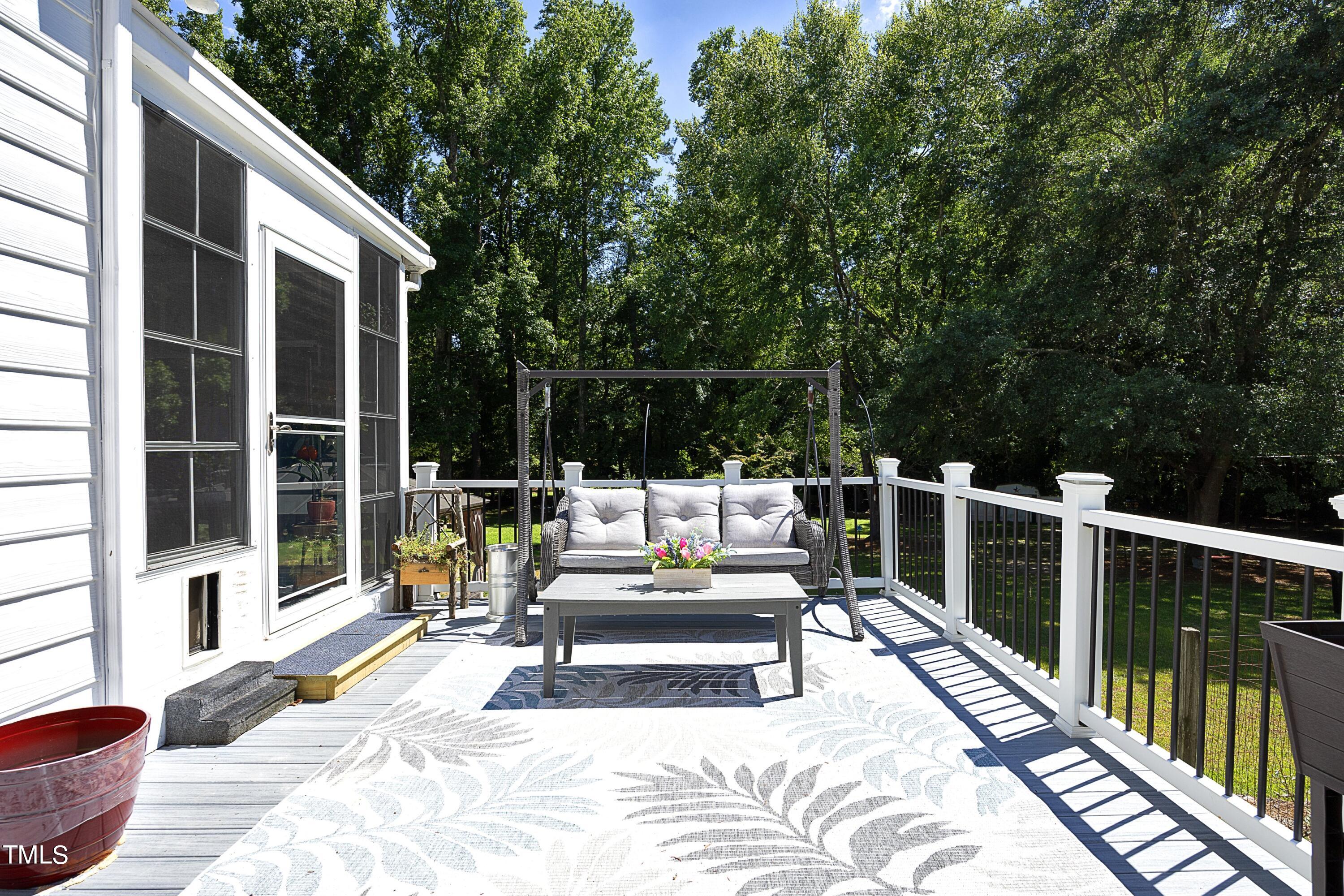 243 Bradley Drive Benson, NC 27504 - Photo 41 of 43 a view of balcony with two chairs and a potted plant