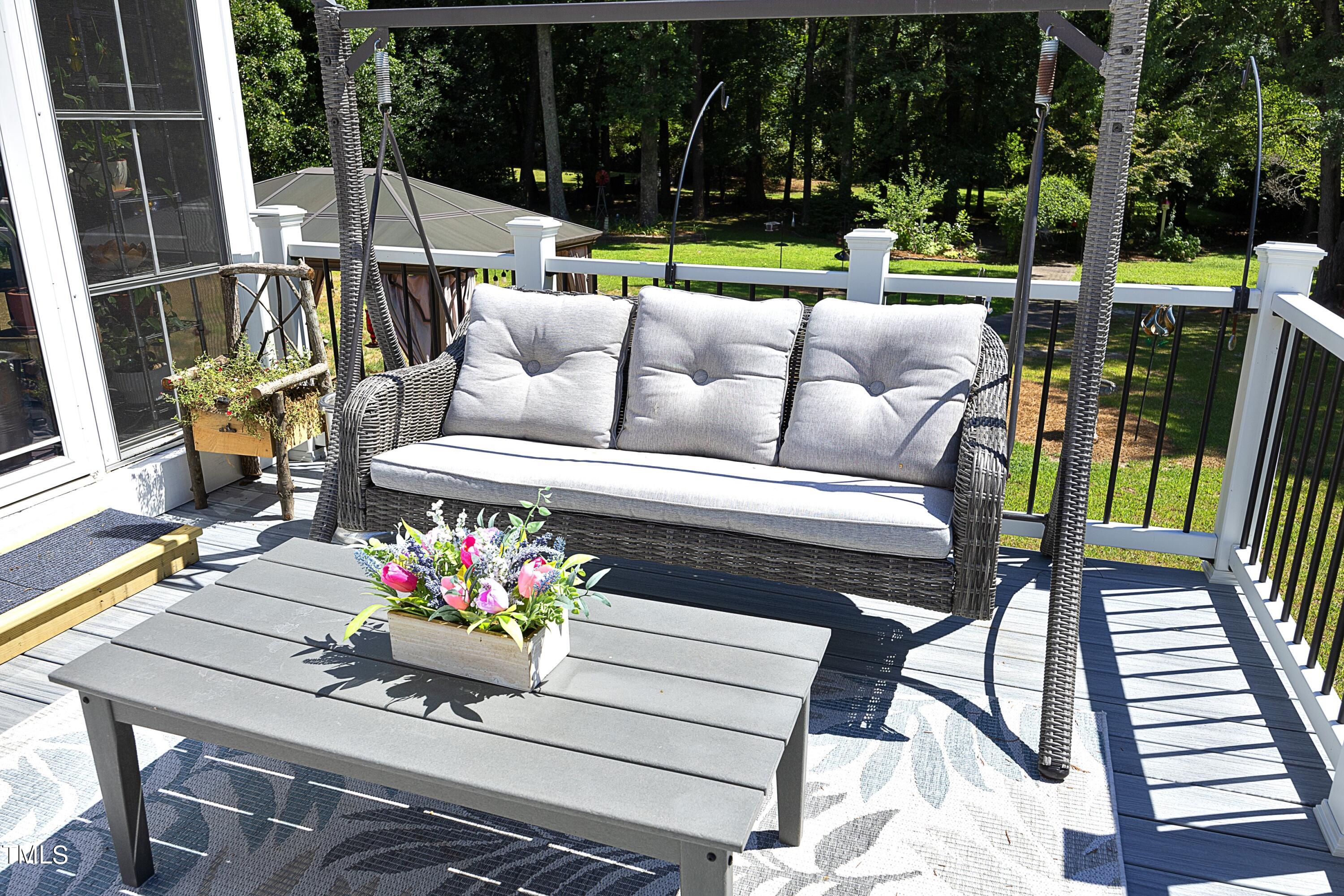 243 Bradley Drive Benson, NC 27504 - Photo 42 of 43 a view of a patio with couches fire pit and a table and chairs