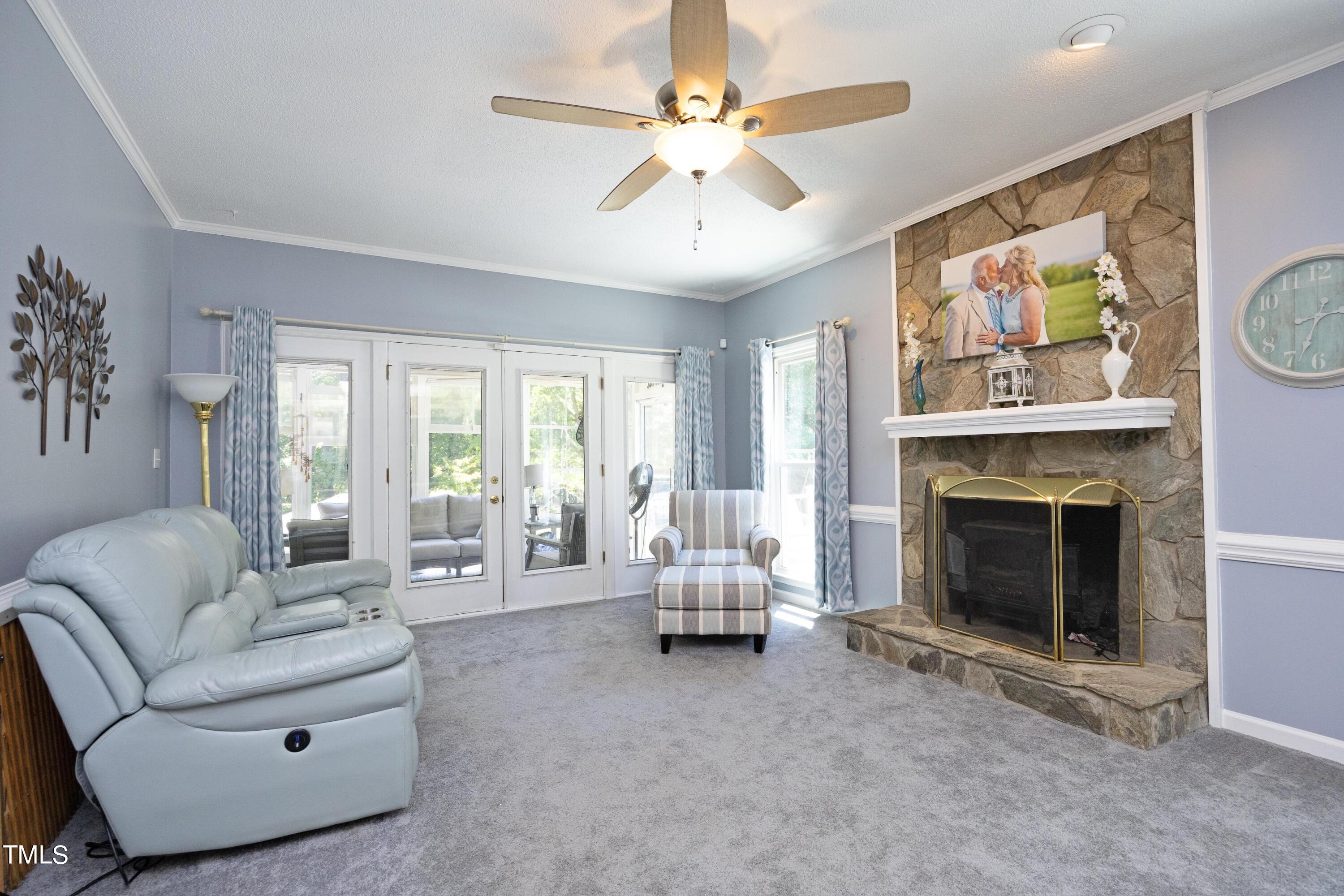 243 Bradley Drive Benson, NC 27504 - Photo 5 of 43 a living room with furniture and a fireplace