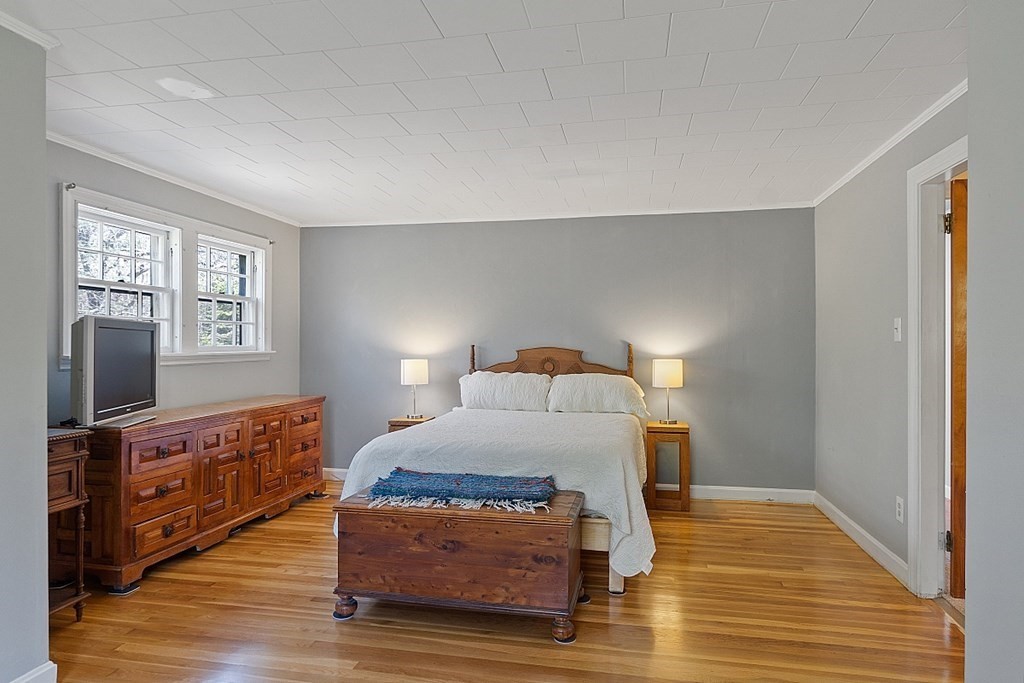 67 Winchendon Road Ashburnham, MA 01430 - Photo 20 of 38 a bedroom with a bed and wooden floor