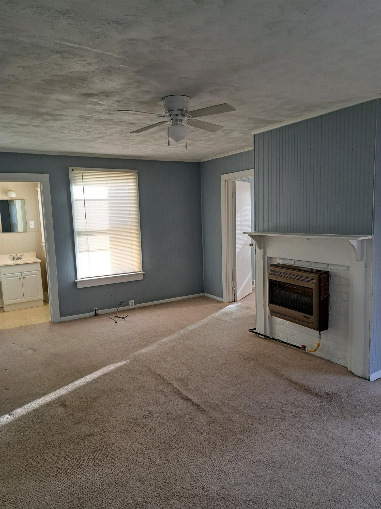 2 Butler Street Jackson, TN 38301 - Photo 4 of 7 an empty room with windows and fireplace