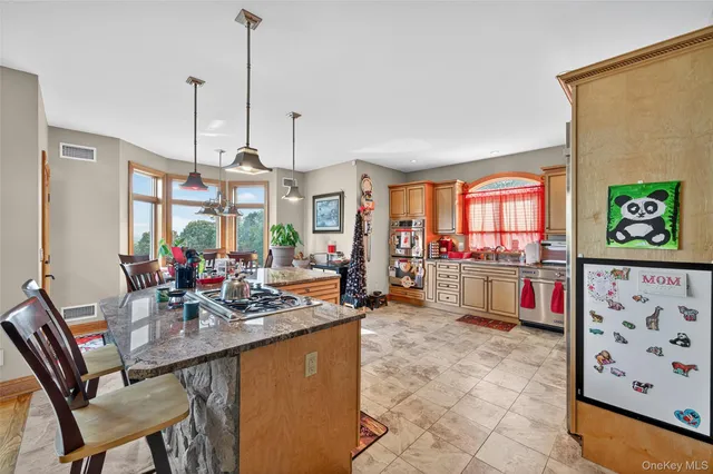 a kitchen with sink refrigerator and microwave