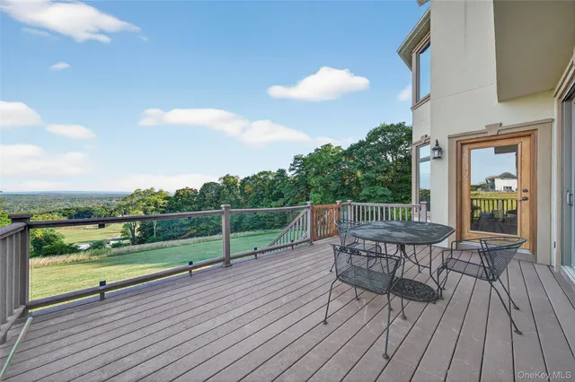 a view of a dining room with furniture and a chandelier
