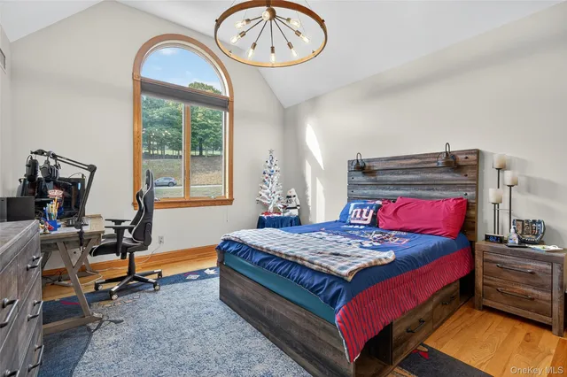 a view of a big room with wooden floor and windows