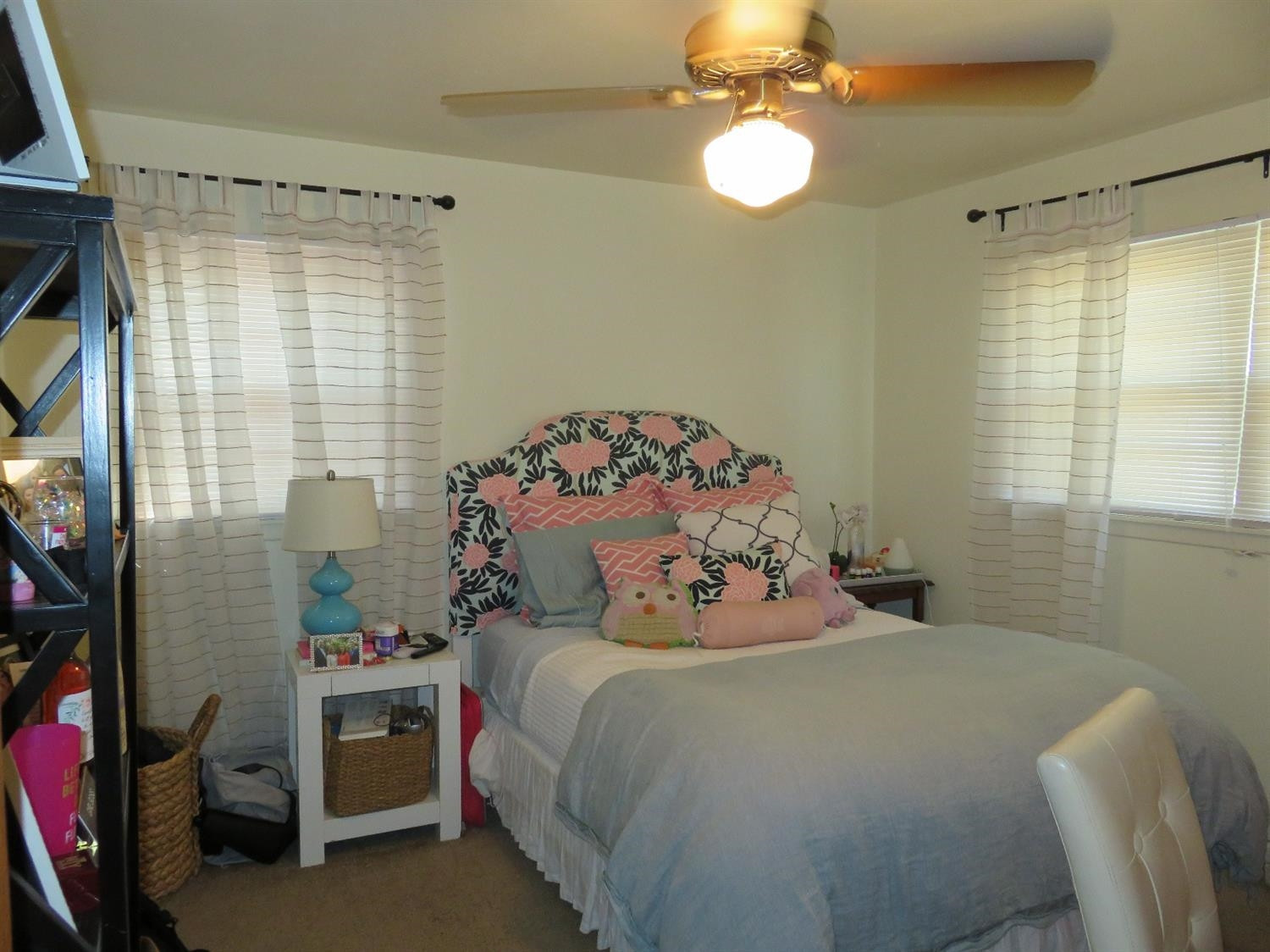 3706 41st Street Lubbock, TX 79413 - Photo 11 of 20 a bedroom with a bed and a chandelier