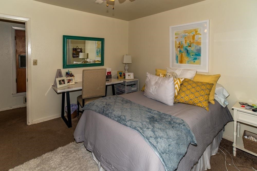 3706 41st Street Lubbock, TX 79413 - Photo 12 of 20 a bedroom with a bed and wooden floor