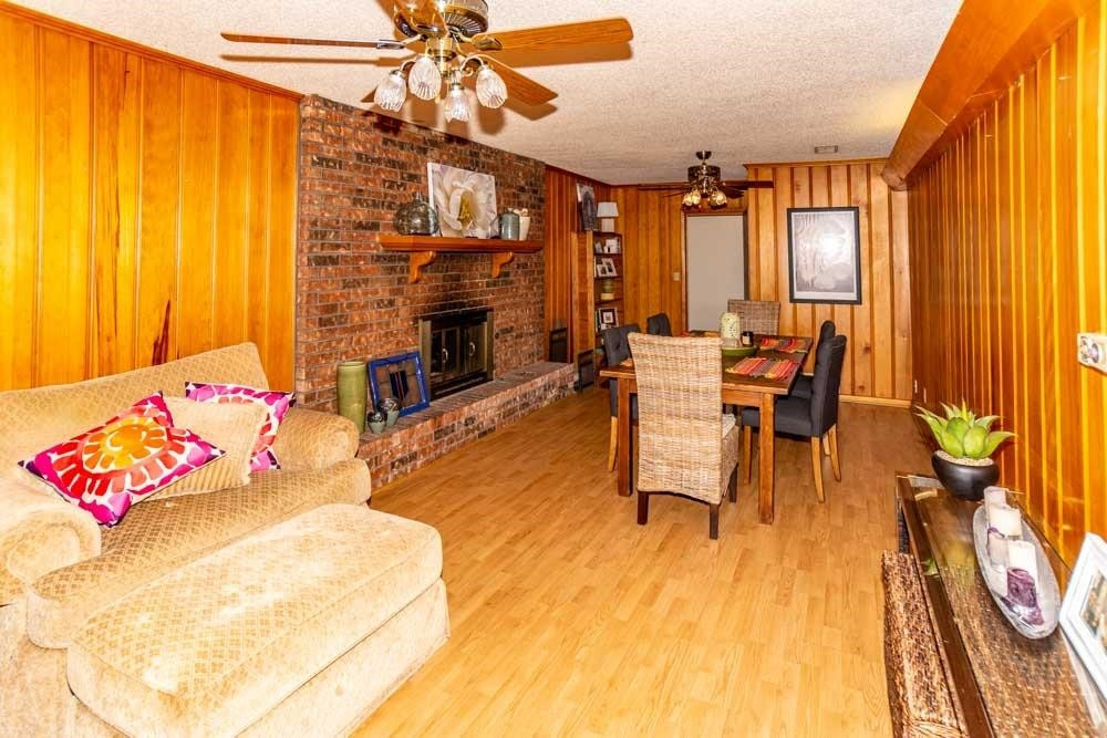 3706 41st Street Lubbock, TX 79413 - Photo 6 of 20 a living room with fireplace furniture and a chandelier