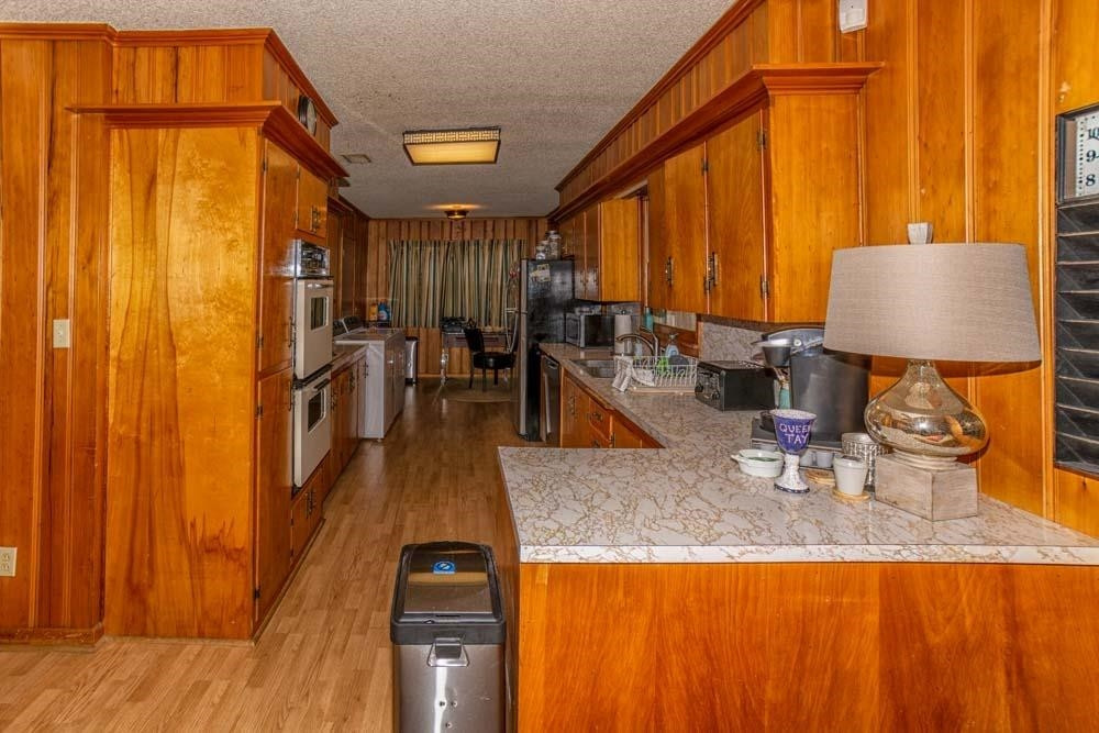3706 41st Street Lubbock, TX 79413 - Photo 7 of 20 a kitchen with sink a refrigerator and chairs