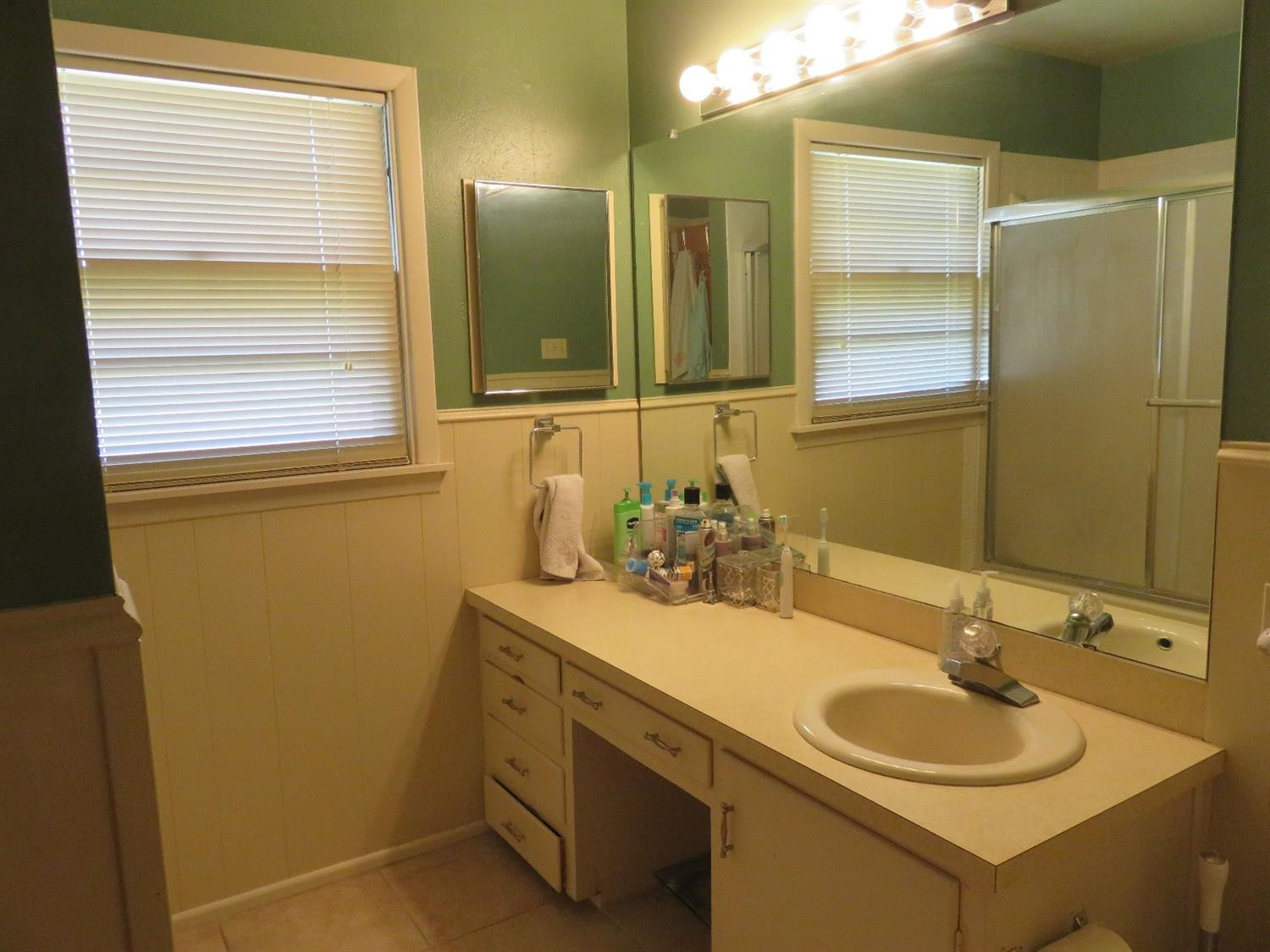3706 41st Street Lubbock, TX 79413 - Photo 10 of 20 a bathroom with a sink and a mirror