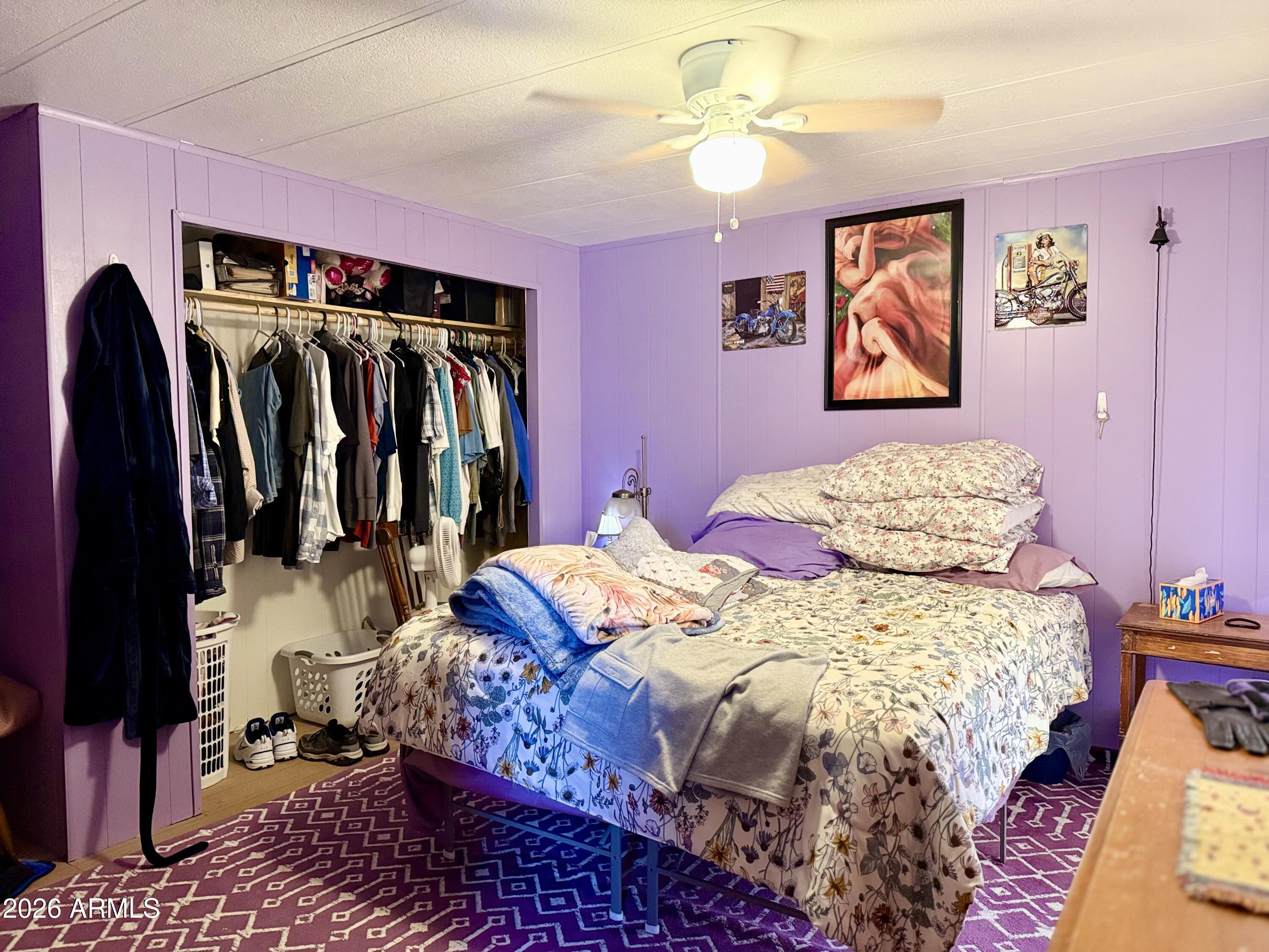 300 Airport Road, Unit 34 Kearny, AZ 85137 - Photo 5 of 18 a bedroom with a bed and a walk in closet