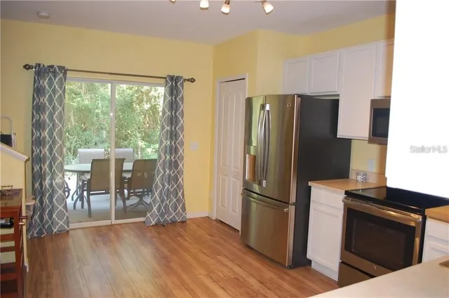 a kitchen with a refrigerator and a table