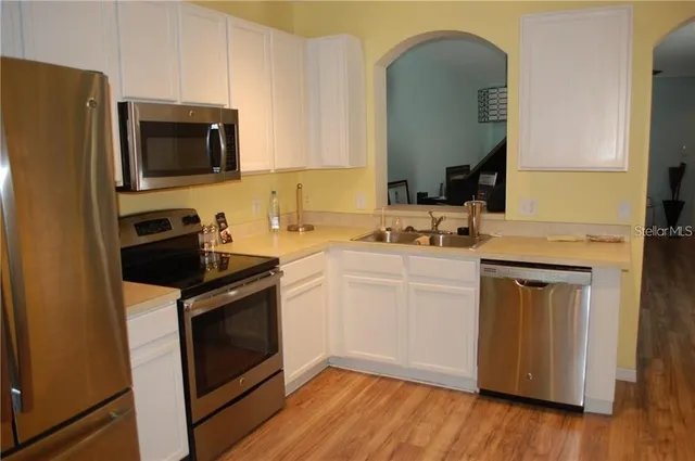 a kitchen with a stove microwave and sink