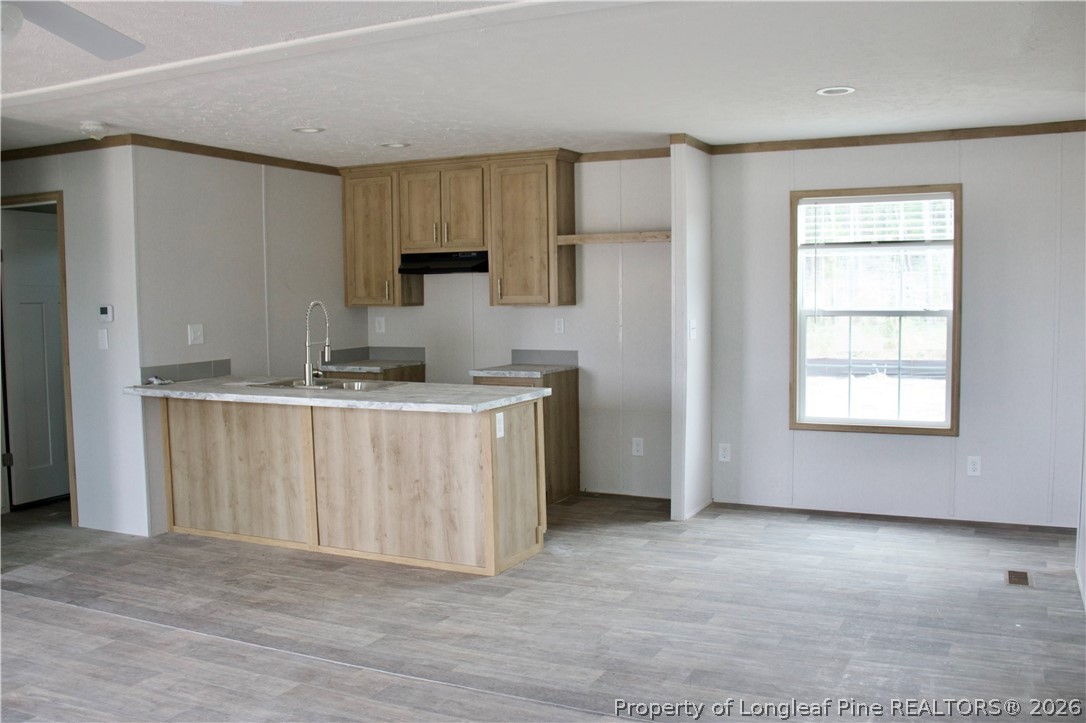 2701 Emma Jane Road St. Pauls, NC 28384 - Photo 7 of 9 a view of kitchen with stainless steel appliances granite countertop a stove a sink and a refrigerator with white cabinets