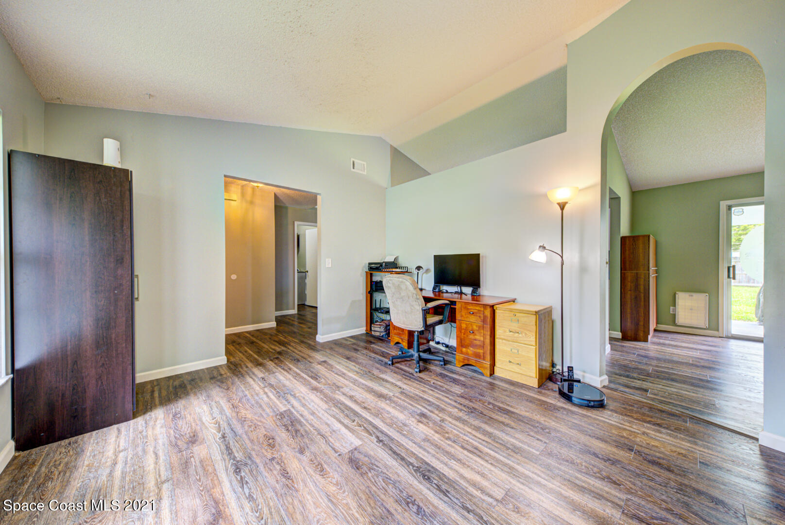 279 Rheine Road Northwest Palm Bay, FL 32907 - Photo 16 of 35 living room with arched doorway