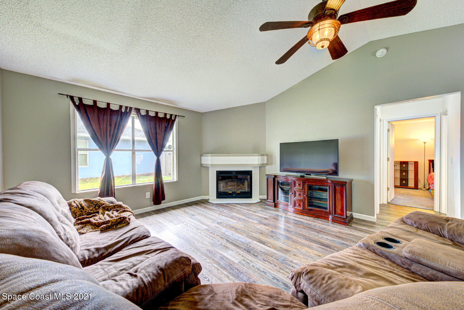 279 Rheine Road Northwest Palm Bay, FL 32907 - Photo 5 of 35 family room with fan