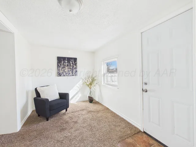 a living room with furniture and a potted plant