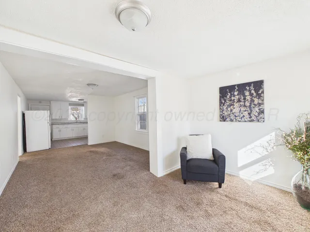 a view of a livingroom with furniture and cabinet