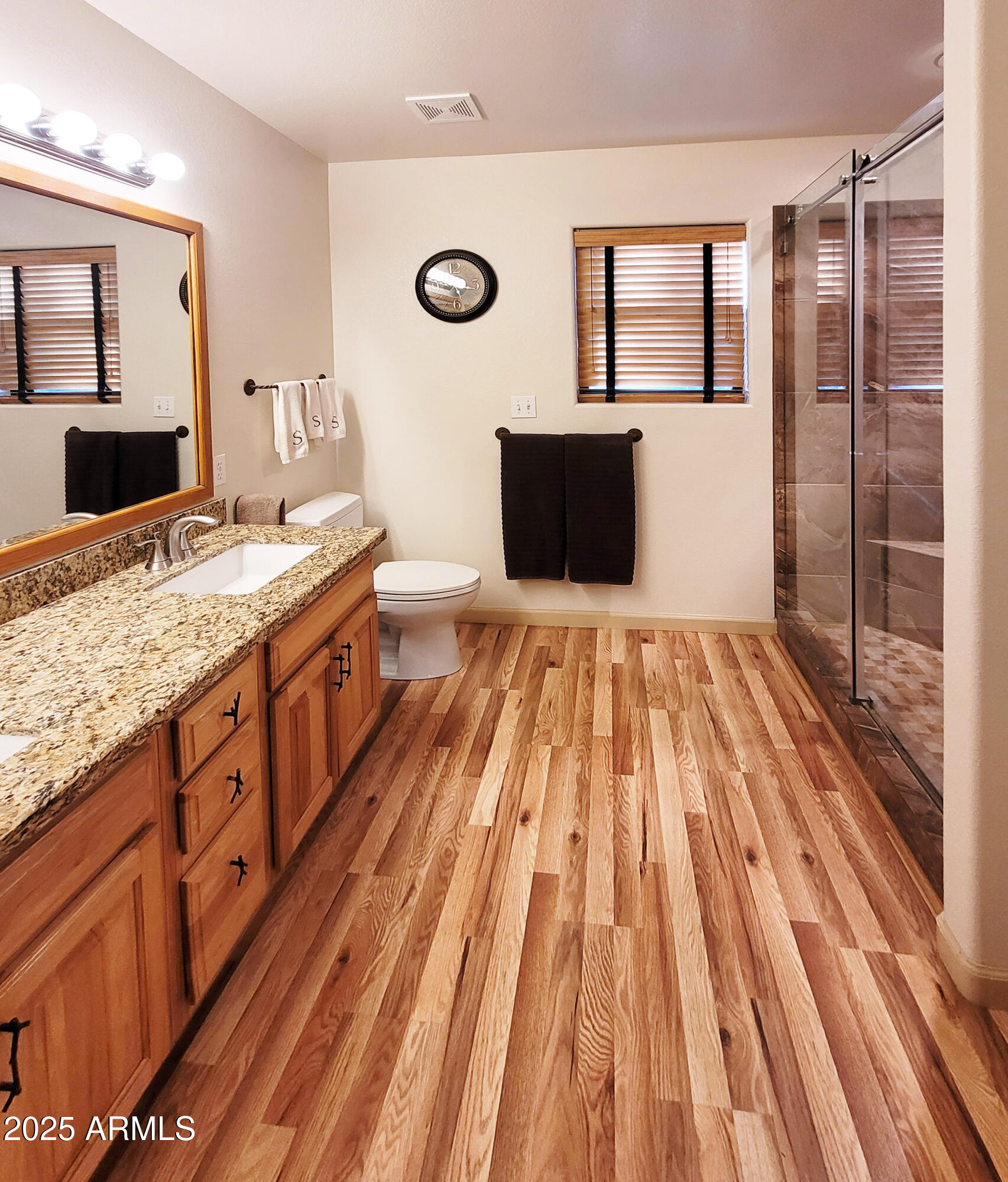 5579 Solitude Trail Loop Pine, AZ 85544 - Photo 30 of 50 a spacious bathroom with a granite countertop sink a mirror and shower