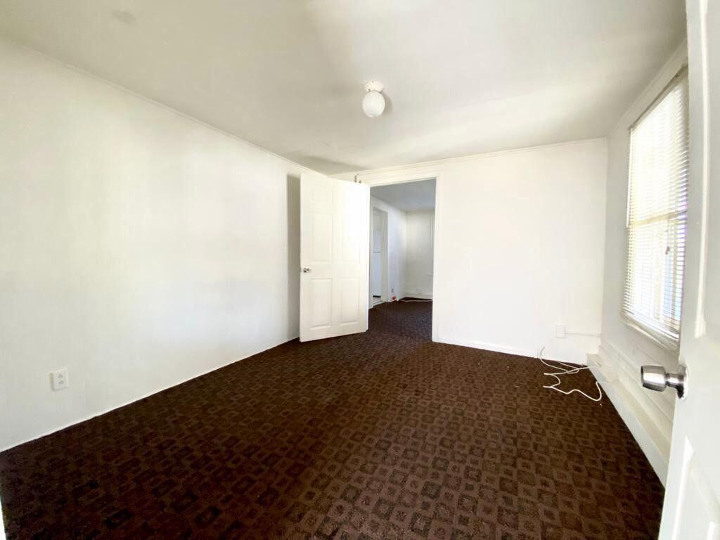 2105 Ponce De Leon Avenue, Unit 2 West Palm Beach, FL 33407 - Photo 3 of 8 an empty room with windows