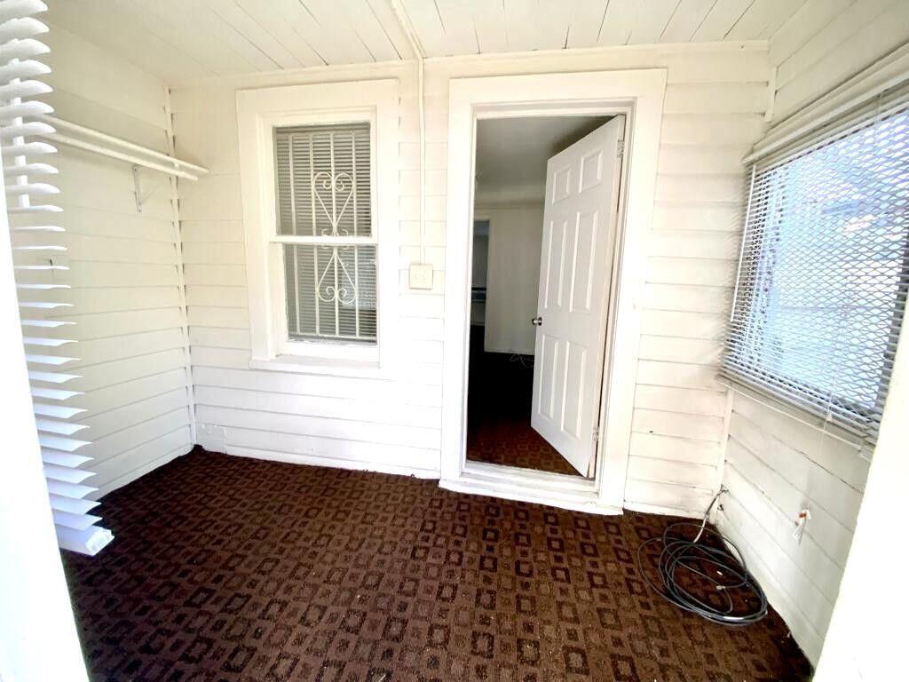 2105 Ponce De Leon Avenue, Unit 2 West Palm Beach, FL 33407 - Photo 4 of 8 a view of an empty room with wooden floor and a window