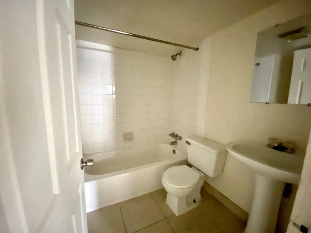 2105 Ponce De Leon Avenue, Unit 2 West Palm Beach, FL 33407 - Photo 6 of 8 a bathroom with a toilet and a bathtub