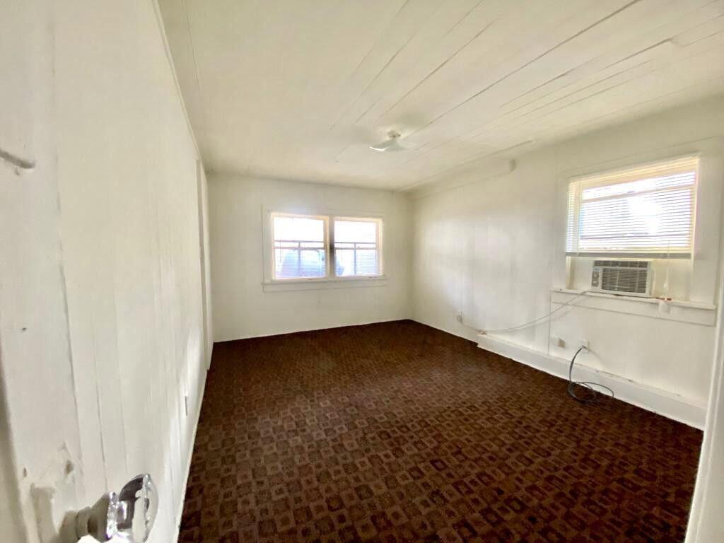 2105 Ponce De Leon Avenue, Unit 2 West Palm Beach, FL 33407 - Photo 8 of 8 an empty room with wooden floor and windows